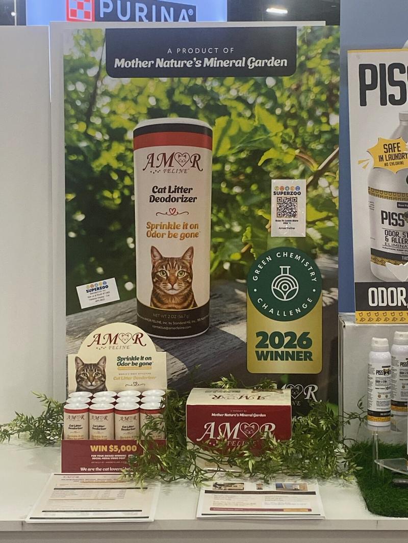 The AMOR FELINE Cat Litter Deodorizer display with canisters, a counter unit and the 2026 Green Chemistry Challenge winner badge